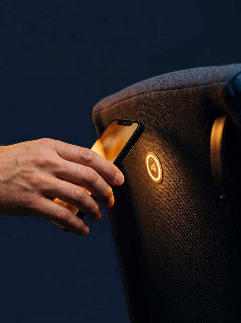 Hand tapping phone on NFC giving sticker on church seat